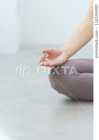 A young woman meditating during an online yoga salon broadcast 118504880