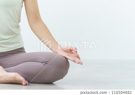 A young woman meditating during an online yoga salon broadcast 118504882