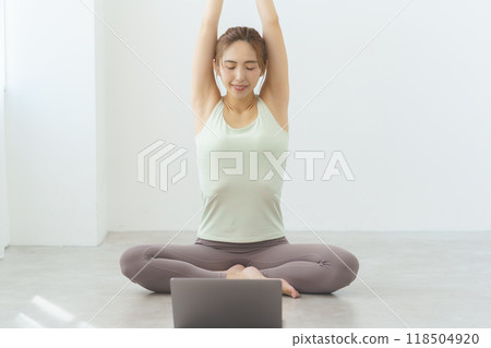 A young woman showing poses in an online yoga salon broadcast 118504920