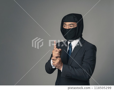 A ninja in a business suit making hand gestures and using ninjutsu techniques 118505299