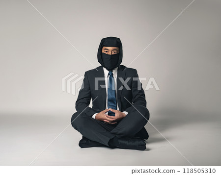 Full-body photo of a ninja in a business suit meditating Full-body photo of a ninja in a business suit meditating 118505310
