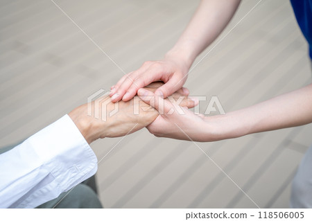 Woman's hand holding senior man's hand Woman's hand holding senior man's hand 118506005