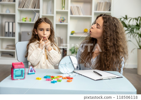Female speech therapist working with a girl on her articulation 118506118