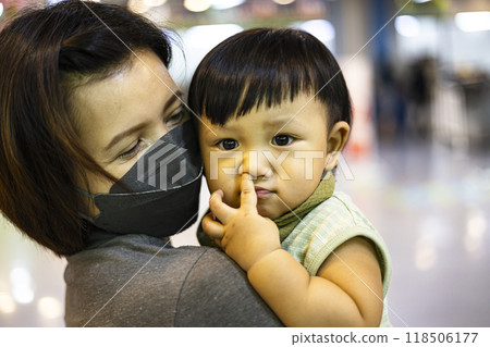 Mother holding her son in her arms. 118506177