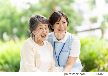 Senior woman walking with a caregiver Senior woman walking with a caregiver 118506820