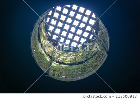 view from the dungeon upwards through a hatch covered with a grate view from the dungeon upwards through a hatch covered with a grate 118506918