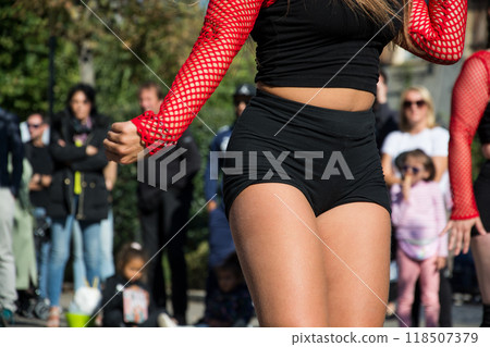 closeup of young woman  dancing in the street with a black shorty 118507379