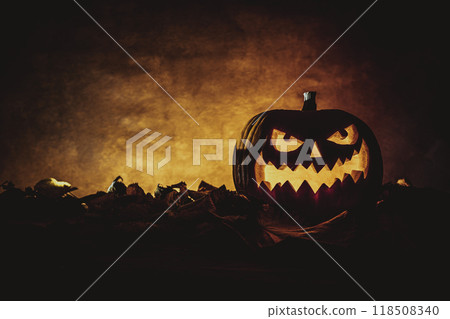 Halloween pumpkin glowing on autumn leaves background Halloween pumpkin glowing on autumn leaves background 118508340