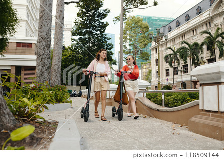 Strolling in City Park with Electric Scooters Strolling in City Park with Electric Scooters 118509144