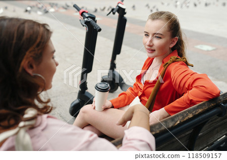 Conversing with Friend While Sitting on Park Bench 118509157