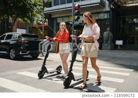 Wearing Casual Clothing While Riding Electric Scooters Wearing Casual Clothing While Riding Electric Scooters 118509172