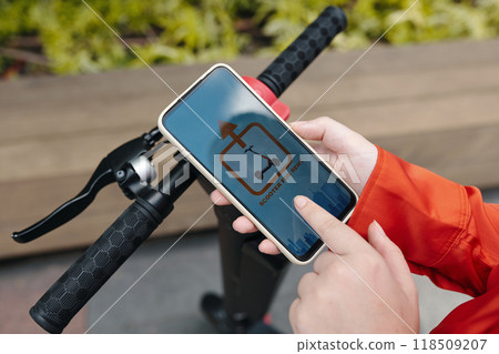 Holding Smartphone with Scooter Sharing App Interface 118509207