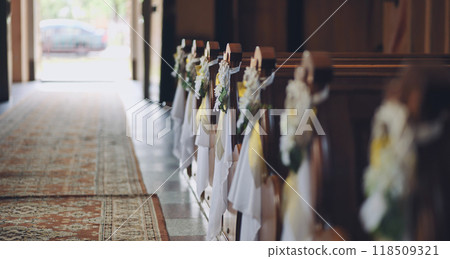 Empty church aisle decorated with flowers for wedding ceremony 118509321