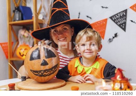 Mother and child carving pumpkin for Halloween 118510260