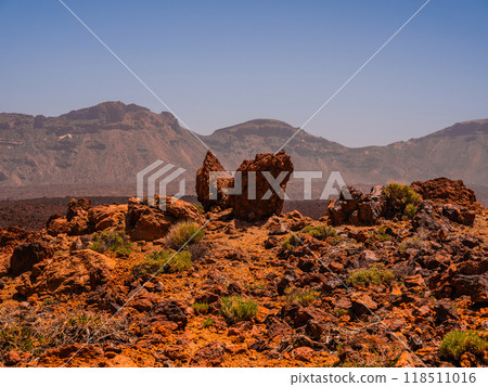 spot in Tenerife with many red rocks and beautiful mountain landscape background 118511016