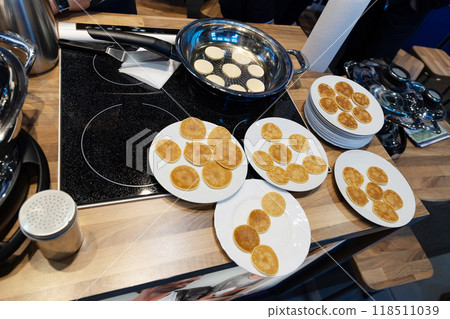 Frying mini pancake cereal in a nonstick frying pan. Frying mini pancake cereal in a nonstick frying pan. 118511039