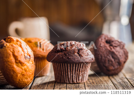 Sweet chocolate muffin cakes. Cupcakes on wooden table. 118511319