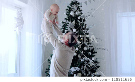 Father and young son playing near Christmas tree shared joy and love warmth of family. Playful interaction between father and little boy by Christmas tree pure love and happiness family gatherings. Father and young son playing near Christmas tree shared joy and love warmth of family. Playful interaction between father and little boy by Christmas tree pure love and happiness family gatherings. 118511656