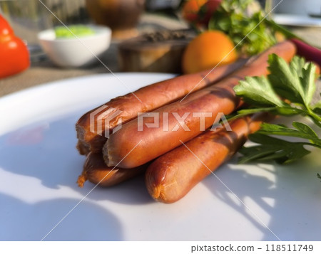 juicy fried sausages lying on a white plate High-quality photo juicy fried sausages lying on a white plate High-quality photo 118511749
