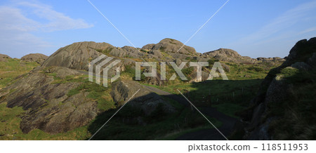 Gravel road and anorthosite rock formations, Rogaland, Norway. 118511953
