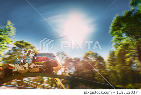 People Having Fun On Rollercoaster In The Park 118512037