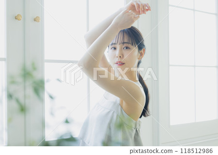 A woman by the window A woman by the window 118512986