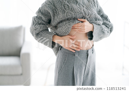 Woman touching her stomach 118513241