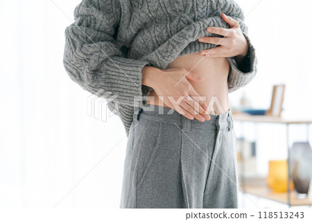 Woman touching her stomach Woman touching her stomach 118513243