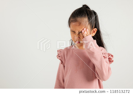 Portrait of Asian young kid girl sad tired strain face holding hold head by hands, stress kindergarten child person unhappy closed eyes problem headache, studio shot isolated on white background Portrait of Asian young kid girl sad tired strain face holding hold head by hands, stress kindergarten child person unhappy closed eyes problem headache, studio shot isolated on white background 118513272