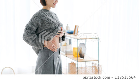 Woman touching her stomach Woman touching her stomach 118513564
