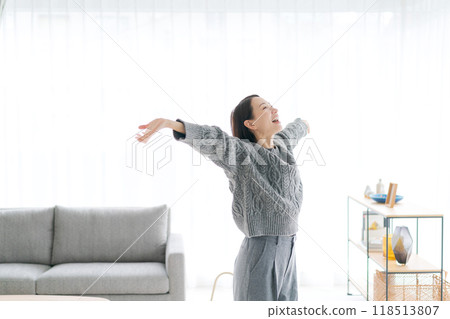 A woman in her 30s stretching at home A woman in her 30s stretching at home 118513807