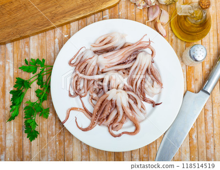 Raw squid tentacles served on plate 118514519