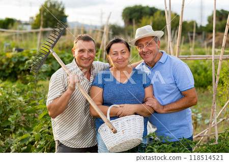 Happy elderly parents and adult son enjoying favorite pastime in garden 118514521