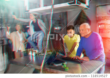 Teenager together with grandfather looking for puzzle solution in quest room 118514527