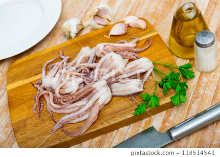 Raw squid tentacles served on plate 118514541