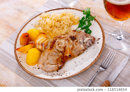 Pork served with pickled cabbage and potatoes 118514654