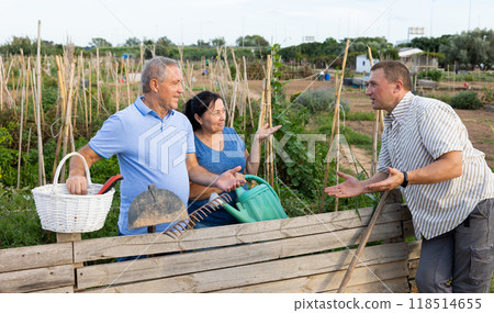 Man talking with neighbours near backyard garden Man talking with neighbours near backyard garden 118514655