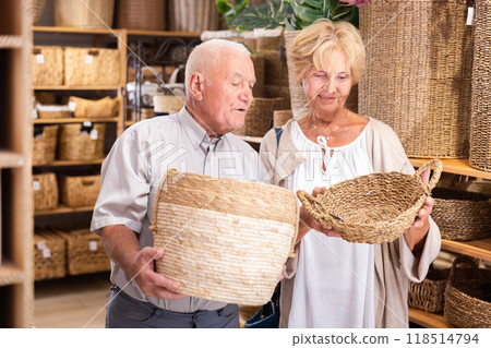Senior couple choosing storage basket at shop Senior couple choosing storage basket at shop 118514794