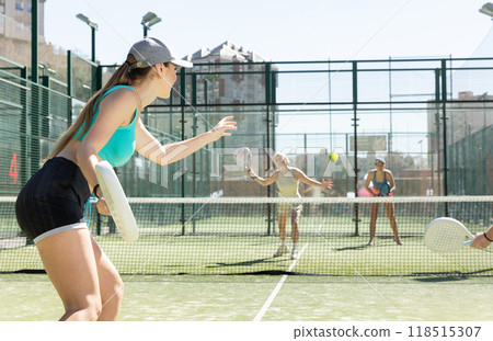 Young woman playing Padel Tennis in pairs in tennis court Young woman playing Padel Tennis in pairs in tennis court 118515307
