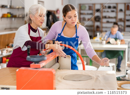 women in pottery workshop work with roller press women in pottery workshop work with roller press 118515373