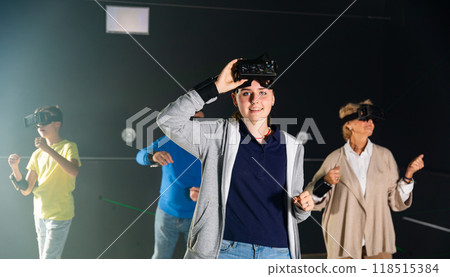 Girl in VR headset playing games with his family 118515384