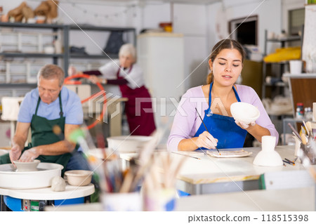 woman paints vase that she made herself woman paints vase that she made herself 118515398
