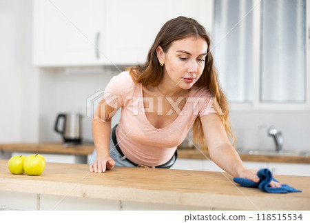 Young woman doing wet cleaning of the kitchen 118515534
