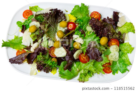 Mixed salad of cucumber, lettuce, tomatoes and olives close up 118515562
