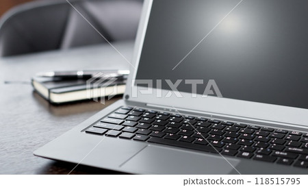 A laptop computer placed on the desk 118515795
