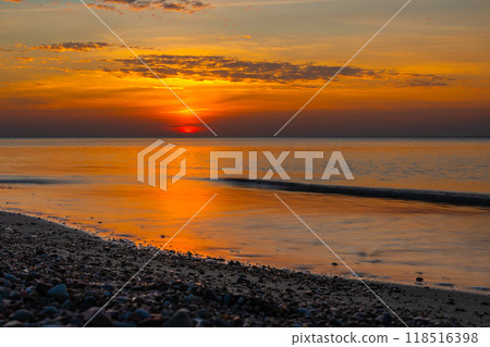Sandy beach with pebbles of Baltic Sea on Curonian Spit at sunset. Kaliningrad region. Russia 118516398