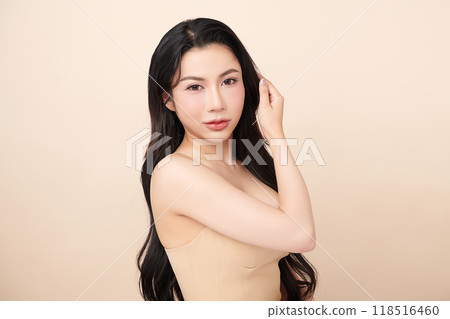 Beautiful young asian woman with clean fresh skin on beige background, Face care, Facial treatment, Cosmetology, beauty and spa, Asian women portrait. Beautiful young asian woman with clean fresh skin on beige background, Face care, Facial treatment, Cosmetology, beauty and spa, Asian women portrait. 118516460