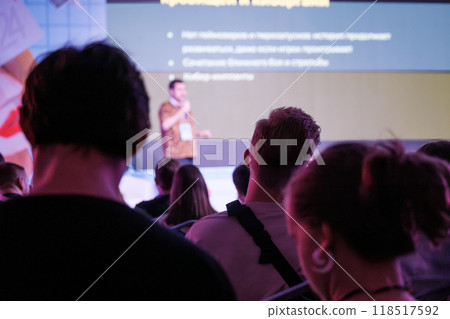 Audience attentively listening to speaker during business presentation Audience attentively listening to speaker during business presentation 118517592