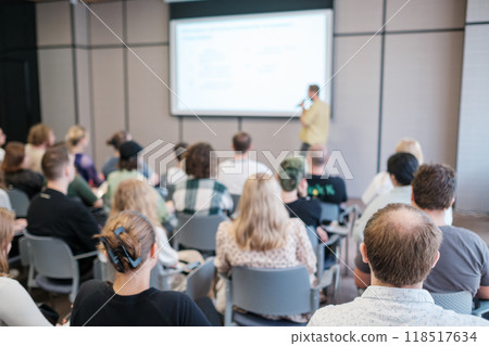 Audience attending a conference with speaker in modern seminar room 118517634
