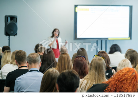 Speaker delivering presentation at business conference to a large audience 118517689